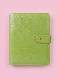 Matcha green crocodile-print A5 six-ring planner by Cavie, flat-lay on a pink background