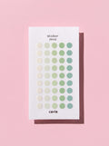 Cavie translucent dot stickers shown styled on a planner page